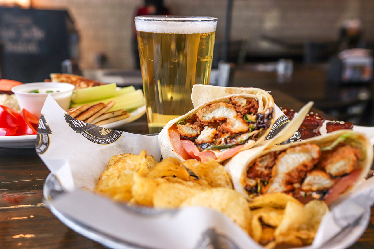 Closeup of food and glass of beer.
